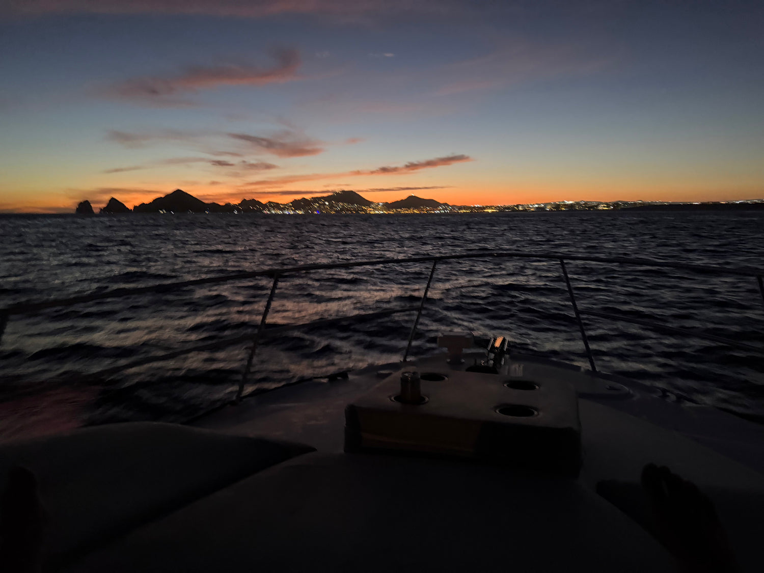 Sunset boat cruise on Okanagan Lake Kelowna - private evening boat rental with city lights and mountain views.