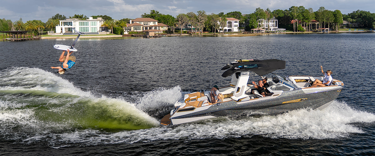 Hydrofoil backflip behind a luxury wake boat rental on Okanagan Lake in Kelowna, BC - ultimate bachelor party water sports.