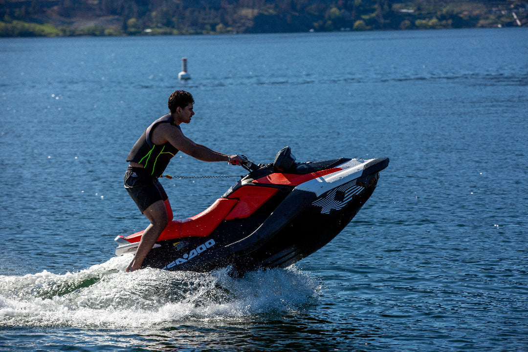 Man doing wheelie on jet ski on a lake