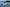 Boat on a lake with mountains and trees in the background