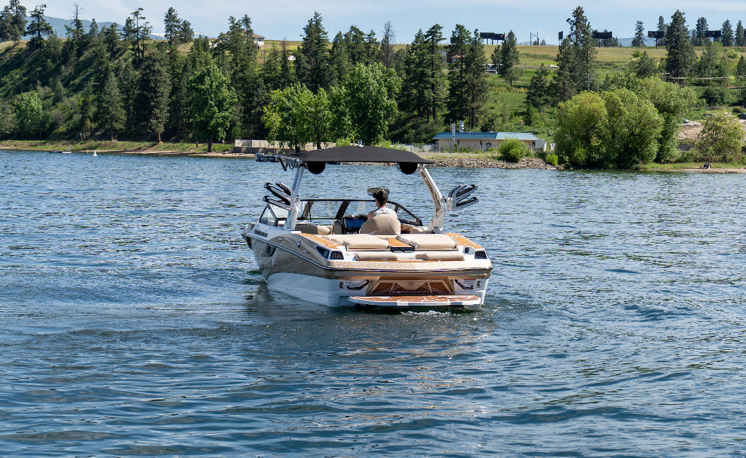 Boat on a lake with trees and clear sky in the background