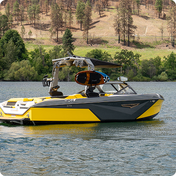 Yellow and black boat on a lake with trees in the background