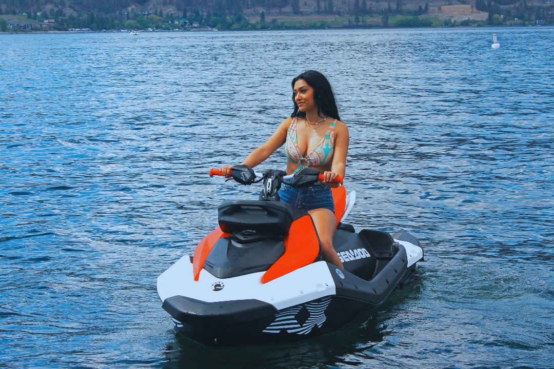 Girl sitting posing while riding jet ski on Lake Okanagan in Kelowna