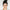 Woman with a stylish hairdo against a plain background